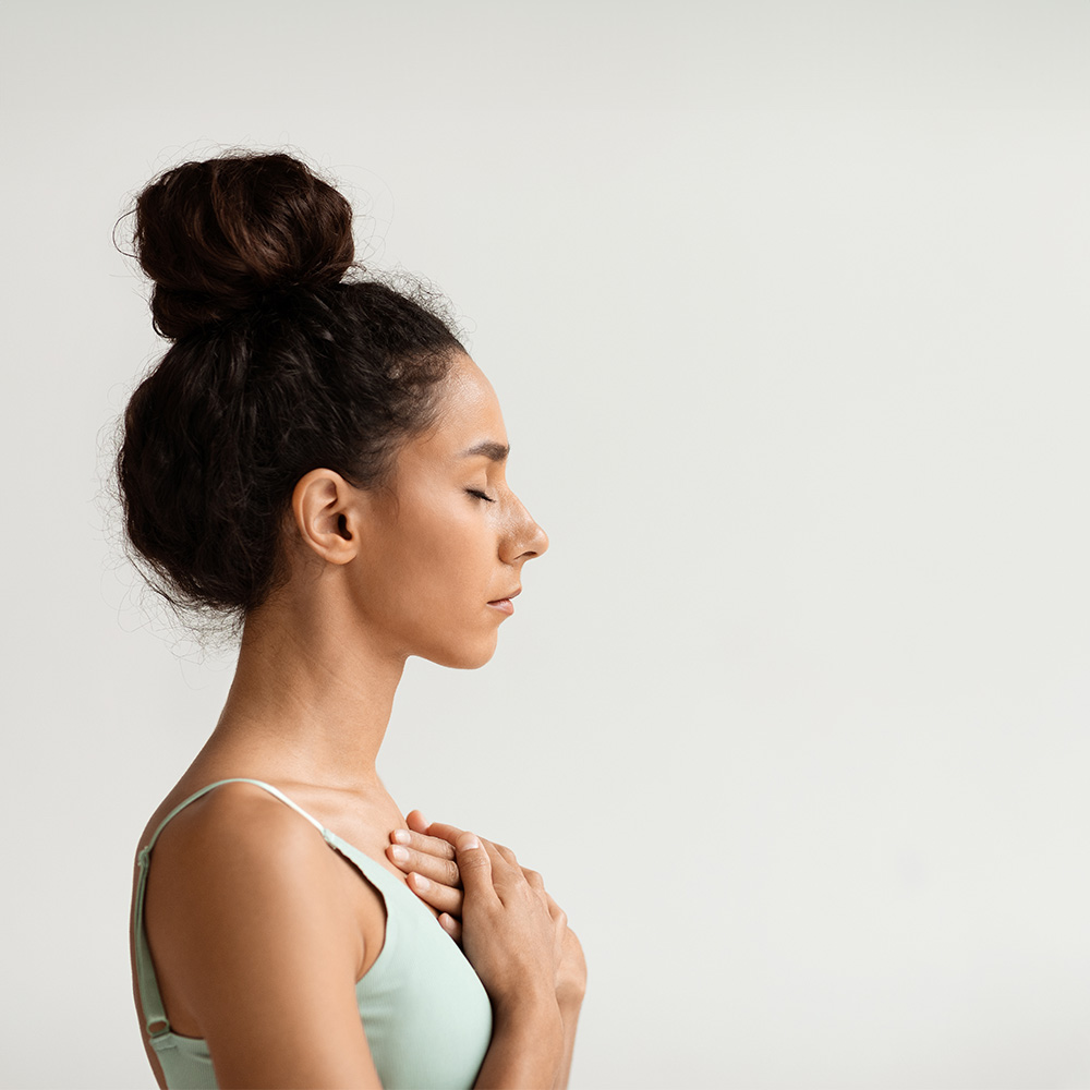 A woman meditating after receiving stress management therapy.